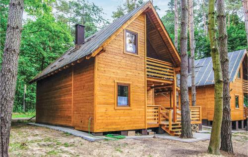 a large wooden cabin in the woods with trees at 2 Bedroom Pet Friendly Home In Ostroda in Ostróda