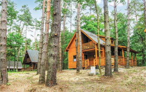 a wooden cabin in the woods with trees at 2 Bedroom Pet Friendly Home In Ostroda in Ostróda