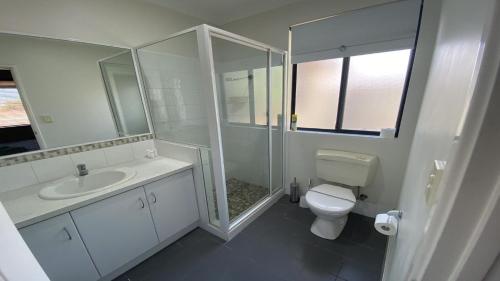 a bathroom with a toilet and a shower and a sink at Adriana Retreat, 20 Adriana Retreat in Jurien Bay