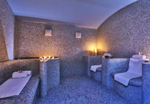 a spa room with two benches and candles at Sitia Beach City Resort & Spa in Sitia