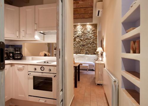 a kitchen with white appliances and a living room at Romantic In Trendy Gracia in Barcelona