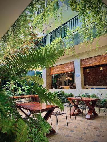 a group of tables and chairs in a courtyard at Fati Boutique Hotel & Apartment in Vung Tau