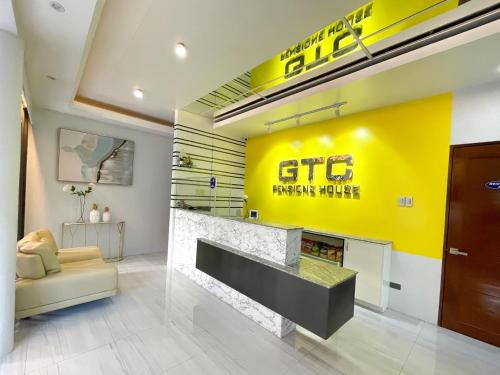 a living room with a fireplace and a yellow wall at GTC Pension House in Santa Rita