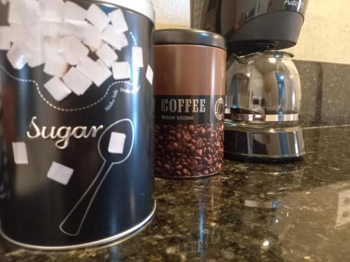 a coffee can sitting on a counter with coffee beans at Ilusion Flats Aconchego de Ponta Negra in Natal