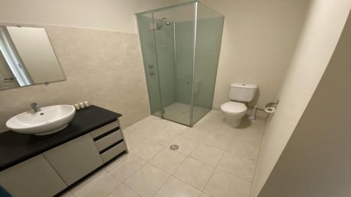 a bathroom with a shower and a sink and a toilet at Unit 63 Seafront Estate in Jurien Bay