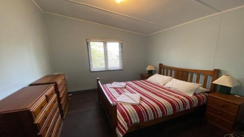 a small bedroom with a bed and a window at Blue Beach House in Jurien Bay