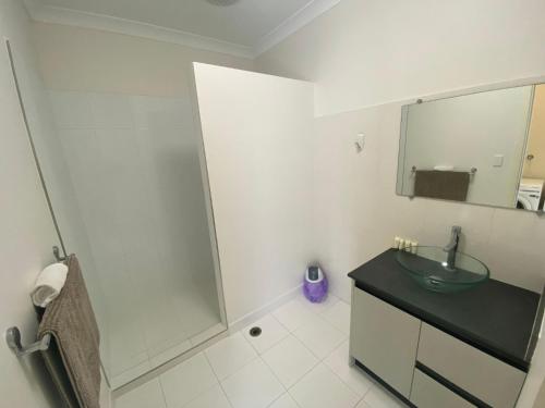 a bathroom with a glass sink and a shower at Unit 27 Seafront Estate in Jurien Bay