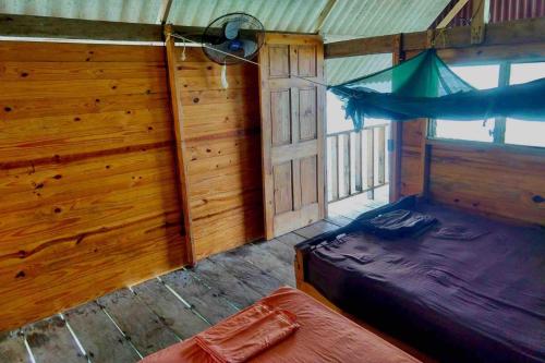 Habitación con cama y hamaca. en Private Cabin Over the Water PLUS Meals - San Blas Islands - private bathroom, en Panamá