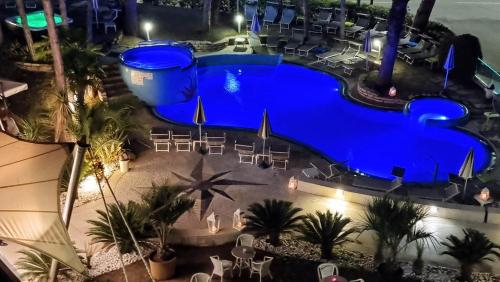 an overhead view of a swimming pool at night at Hotel Mediterraneo in Lignano Sabbiadoro