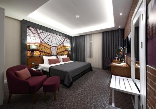 a hotel room with a bed and a chair at Montania Special Class Hotel in Mudanya