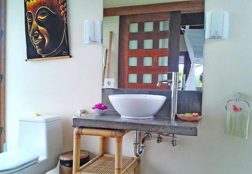 a bathroom with a bowl sink on a counter at Duke's Bingin Villas in Uluwatu