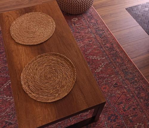 two wicker objects sitting on a wooden coffee table at Cottage Toladi in Stepantsminda