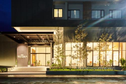 a store front of a building with large windows at Centara Life Wisma Hotel Ratchaburi in Ratchaburi