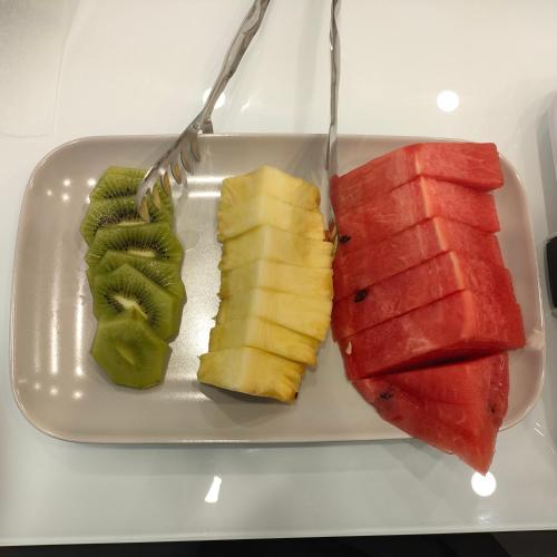a plate with watermelon and fruit on a table at Maison Nanà in Sorrento
