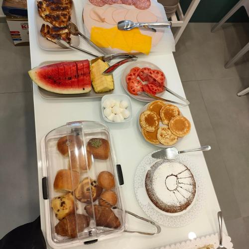 a white table with a bunch of different types of breakfast foods at Maison Nanà in Sorrento