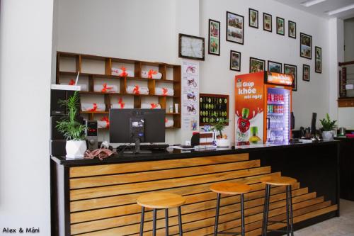 a restaurant with a counter with two stools at Bong Hostel and Motorbike Tour in Ha Giang