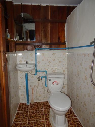 a small bathroom with a toilet and a sink at Zest'house in Koh Rong Island