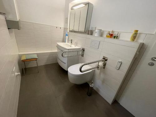 a bathroom with a toilet and a sink and a mirror at Entspannung und Ruhe vor den Toren Berlins in Königs Wusterhausen