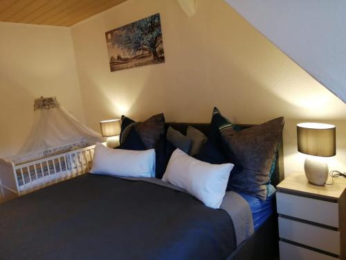 a bedroom with a large black bed with pillows at Ferienwohnung altes Steinlager in Oderberg