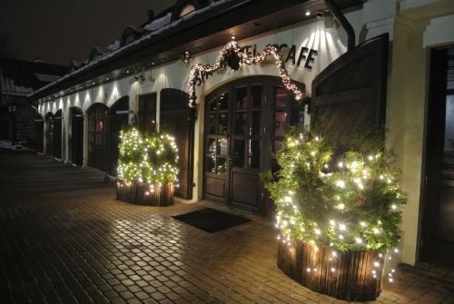 a street with christmas trees in front of a building at Vecgulbenes muiža in Gulbene