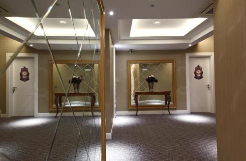 a hallway with two mirrors in a room at Montania Special Class Hotel in Mudanya