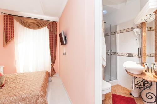 a bathroom with a bed and a sink and a toilet at Impero Vaticano San Pietro in Rome