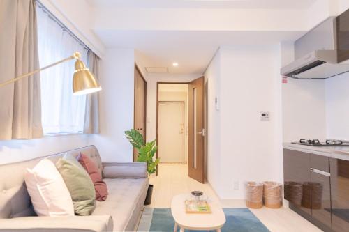a living room with a couch and a table at Tokyo Sunshine Tower Premium Hotel in Tokyo