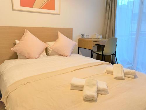 a bedroom with a bed with towels on it at Tokyo Sunshine Tower Premium Hotel in Tokyo