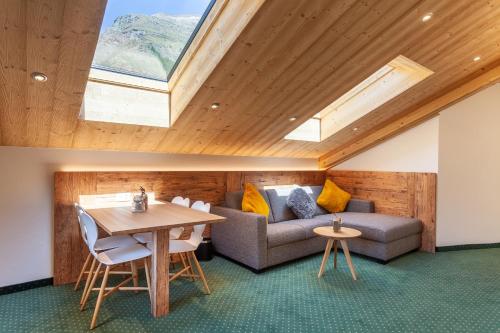 a living room with a couch and a table at Hotel Jägerhof in Zermatt