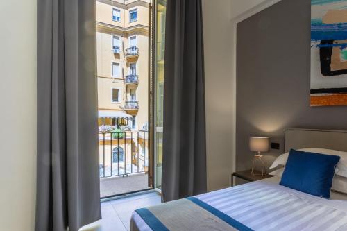 a bedroom with a bed and a large window at Bespoke Roma Suites in Rome