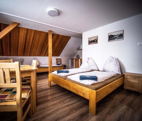 a bedroom with two bunk beds and a desk at Penzion Samoty in Železná Ruda