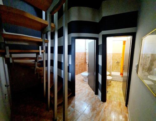 a bathroom with black and white stripes on the walls at Apartman 993 in Pale
