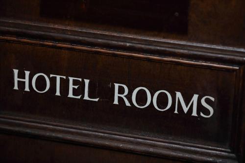 a hotel room sign on a wooden door at The Avenue in Durham