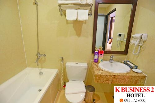 a bathroom with a tub and a toilet and a sink at K Business 2 Hotel My Dinh 미딩 in Hanoi