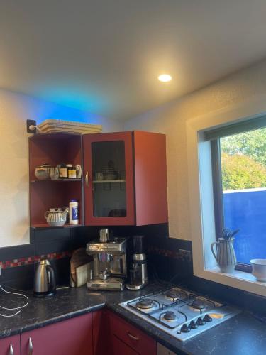 a kitchen with a stove top and a window at Big Fully Equipped 3BRM Quiet Farm House Near Beach & 12 min to Town in Riverton