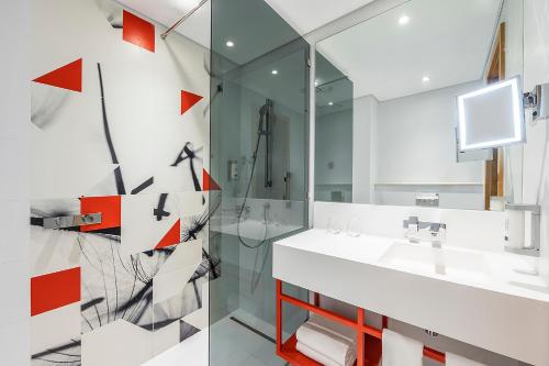 a bathroom with a sink and a mirror at Studio M Arabian Plaza Hotel & Hotel Apartments in Dubai