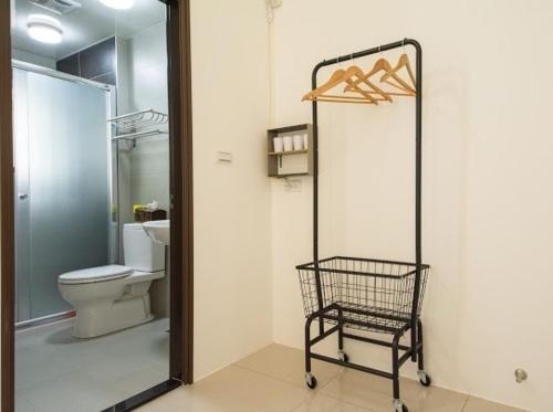 a bathroom with a toilet and a shopping cart at Chang Hiong Homestay in Yilan City