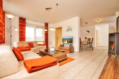 a living room with a couch and a tv at Ferienhaus am Johannesbuhl in Waldmünchen