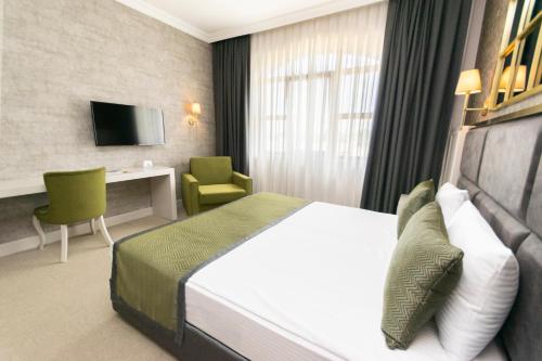 a hotel room with a bed and a desk at CONNECT THERMAL HOTEL in Ankara