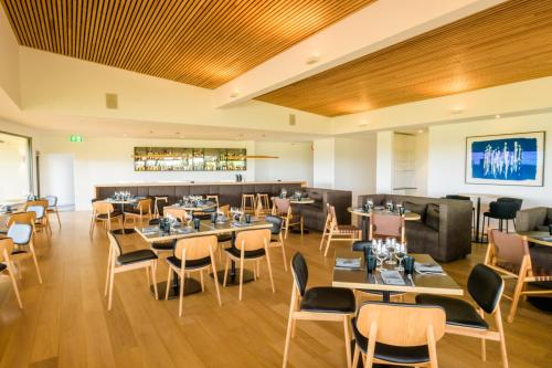 a restaurant with tables and chairs and a bar at The Louise in Marananga