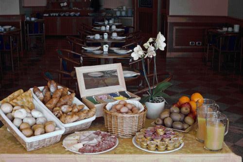 a table topped with lots of different types of food at Hotel Florida Lerici in Lerici