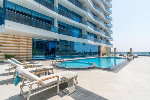 a swimming pool in front of a building at Exclusive GLOBALSTAY Apartments in Business Bay Free Parking & More! in Dubai