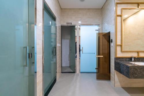 a bathroom with a glass door and a sink at Exclusive GLOBALSTAY Apartments in Business Bay Free Parking & More! in Dubai