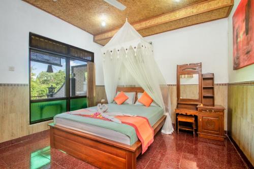 a bedroom with a bed with a canopy at Sulendra Jungle Suites Ubud View by EPS in Ubud