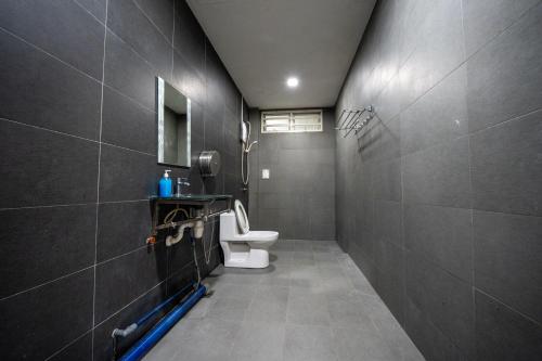 a bathroom with a toilet and a sink at Jack Guest House KB 5 Rooms 4 Toilets - Max 20 pax in Kota Bharu