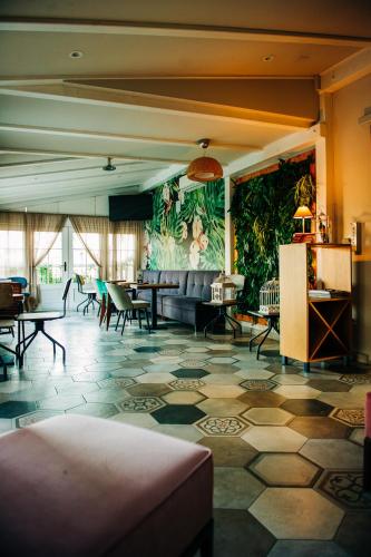 a lobby with a couch and chairs in a room at Sundial Boutique Hotel in Zagreb