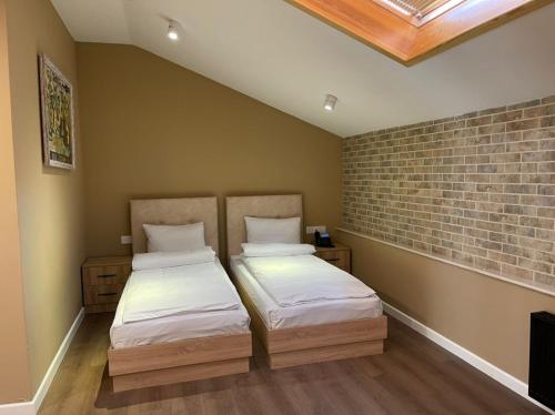 Postel nebo postele na pokoji v ubytování OLF Hotel