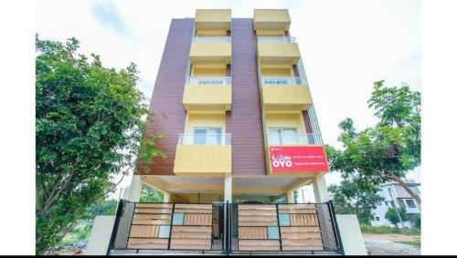 a tall building with a fence in front of it at HOTEL SLN INN in Bangalore