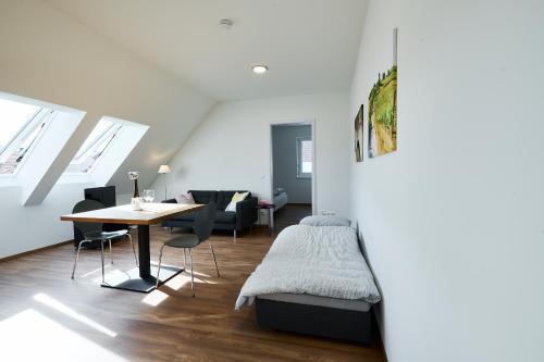 1 dormitorio con 1 cama y 1 mesa en una habitación en Ferienwohnungen im Weingut Huff-Doll, en Horrweiler
