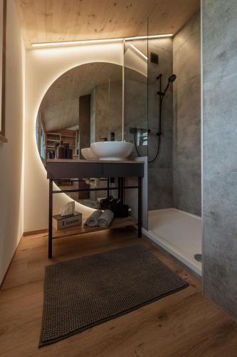 a bathroom with a sink and a shower and a tub at Ländleapartments in Höchst